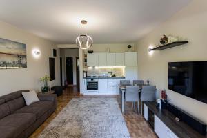 a living room with a couch and a kitchen at Villa Nova in Đenovići