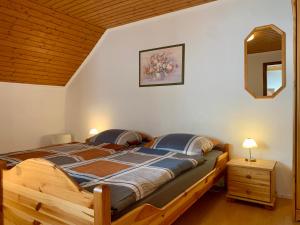 a bedroom with a wooden bed in a room at Ferienwohnung Cäcilia im idyllischen Haus Kommeles - Leiwen an der Mosel in Leiwen
