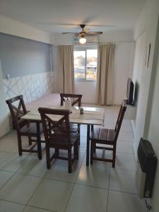 a dining room with a table and chairs and a television at Villasol Temporario in Córdoba