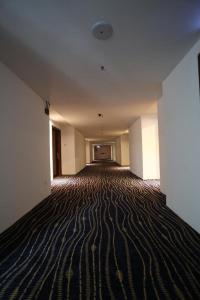 an empty room with a striped floor in a building at Townhouse OAK 591 Shah Alam By Salaam Suites in Shah Alam
