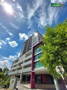 wysoki budynek z niebieskim niebem w tle w obiekcie Townhouse OAK 591 Shah Alam By Salaam Suites w mieście Shah Alam