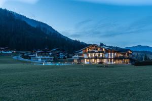 a large building in the middle of a field at Purest in Achenkirch