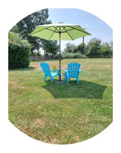two blue benches sitting under an umbrella in a field at B&B Franglaise in Romagne
