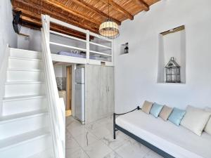 a living room with a couch and a staircase at Lindo House in Lefkes