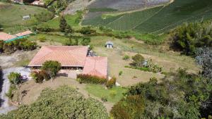 an aerial view of a house with a farm at Casa de Campo vía El Peñol Guatapé in Marinilla