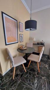 a dining room with a table and two chairs at Cosy Retro Apartment in Zakynthos Town