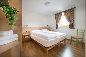 A bed or beds in a room at Chalet Elena