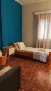 a bedroom with a large bed and a window at Cosy Retro Apartment in Zakynthos Town