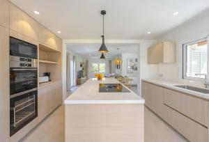 a kitchen with white counters and a large kitchen island at Cielo de Bonaire in Alcudia