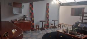 a waiting room with a couch and stools at Apu Verónica in Cusco