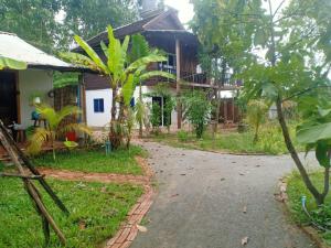 a house with a road in front of it at Yi family Homestay in Siem Reap