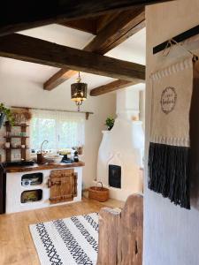 a kitchen with a stove top oven in a room at Inside, The Village- Rooster's Nest 