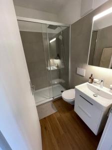 a bathroom with a shower and a toilet and a sink at Stay Swiss 1 bedroom apartments in old town in Porrentruy