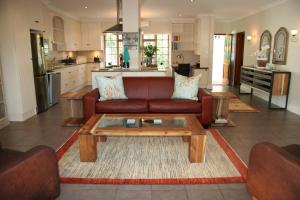 a living room with a couch and a coffee table at Cape Robin Cottage in Franschhoek