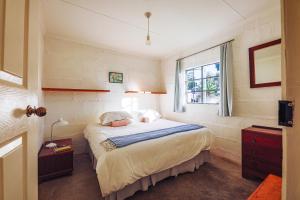 a bedroom with a bed and a window at The Old Mushroom Farm in Howick
