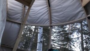 an inside view of a tent with trees in the background at dôme près du lac in Saint-Narcisse-de-Rimouski +6 photos