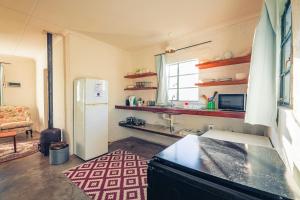 a kitchen with a refrigerator and a sink in it at The Old Mushroom Farm in Howick