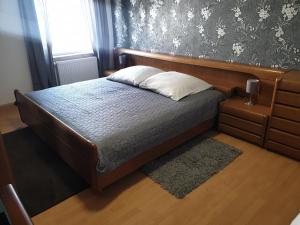 a bedroom with a bed with a wooden headboard at Gästewohnung in Pirmasens