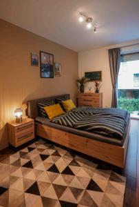 a bedroom with a bed and a checkered floor at Danube Family Premium Apartment in Budapest