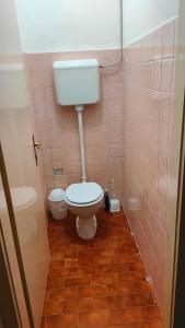a bathroom with a toilet and a tiled floor at Eleonora in Koper