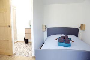 a bedroom with a bed with a blue bag on it at Gîte Les amoureux de la Baie in Favières