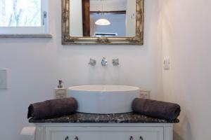a bathroom with a sink and a mirror at Piemonte Country House in Agliano Terme