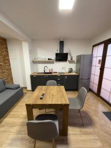 a kitchen with a table and chairs in a living room at Route 7 Rooms in Myślenice