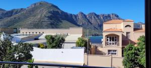 a view of a building with a mountain in the background at Leehaven Apartment in Hout Bay