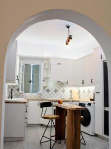 an archway in a kitchen with a table and chairs at Lithi Stylish Apartments- Eco Luxury Suite in Tripití