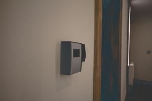 a soap dispenser on a wall next to a door at Apartamenty Lesko 23 in Lesko