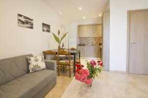a living room with a couch and a table with flowers at Villa Giorgos in Kefalos