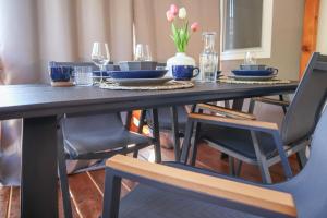 a dining room table with blue plates and chairs at Mobile home MARIS in Sveti Juraj
