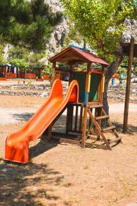 a playground with an orange slide and a gazebo at Mobile home MARIS in Sveti Juraj