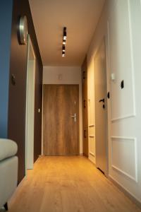 an empty hallway with a wooden door in a room at Apartamenty Lesko 23 in Lesko