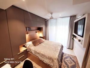 a bedroom with a bed and a large window at Luxury Suite - סוויטת בוטיק in Caesarea +67 photos