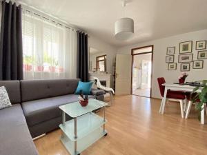 a living room with a couch and a table at Lovely Apartment Marina Blue in Skrbčići