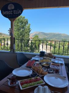 a table with plates of food on a table with a view at İmroz Elia Otel in Gokceada Town