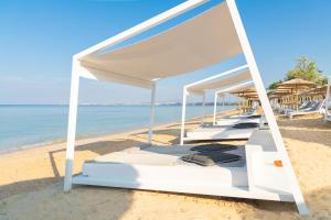 a row of beds on the beach at Potidea Palace Hotel in Nea Potidaea