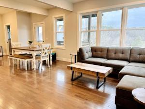 a living room with a couch and a table at French Broad Overlook in Asheville