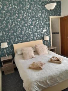 a bedroom with a bed with two towels on it at Legends Hotel in Blackpool