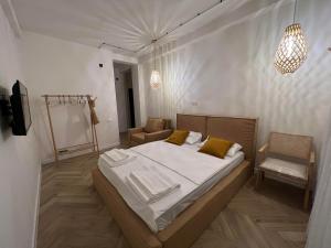 a bedroom with a bed and a chair and lights at LIMANI in Grigoleti