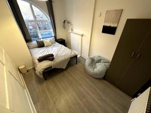 a small bedroom with a bed and a window at Spectacular 2 bedroom on Tower Bridge in London