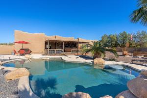 een zwembad in een tuin met een huis bij Cozy quiet home BBQ Pool Outdoor entertaining in Phoenix