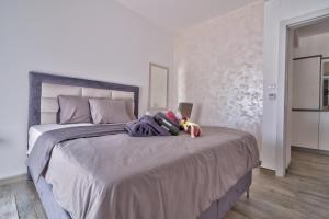 a bedroom with a large bed with a laptop on it at Vision apartmani Vrnjačka Banja in Vrnjci
