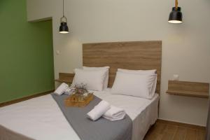 a bedroom with a large bed with white sheets and pillows at Arismari House in Ravdhoúkha +22 photos