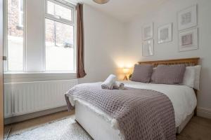 a bedroom with a bed with a teddy bear on it at Spacious Apartment in Jesmond with Parking in Jesmond