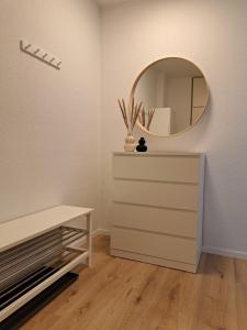a dressing room with a mirror and a dresser at Harz-Glück-Fewo in Bad Harzburg