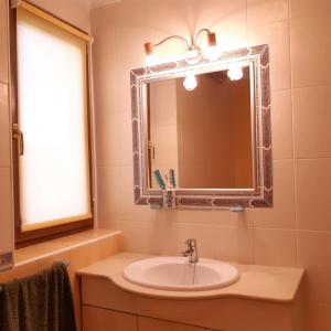 a bathroom with a sink and a mirror at Casa Auela Maria in Bocairent