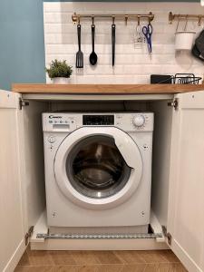 a laundry room with a washing machine in a kitchen at Aquarium Exclusive Loft - Free Parking in Genova