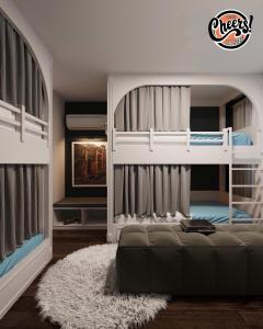 a bedroom with two bunk beds and a rug at Cheers Hostel Hanoi in Hanoi